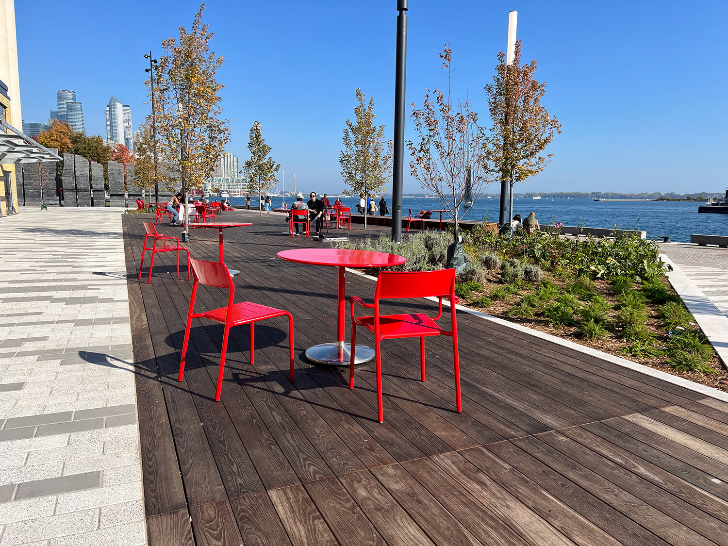 Maglin Foro tables and chairs at Bathurst Quay Commons on sunny day next to lake
