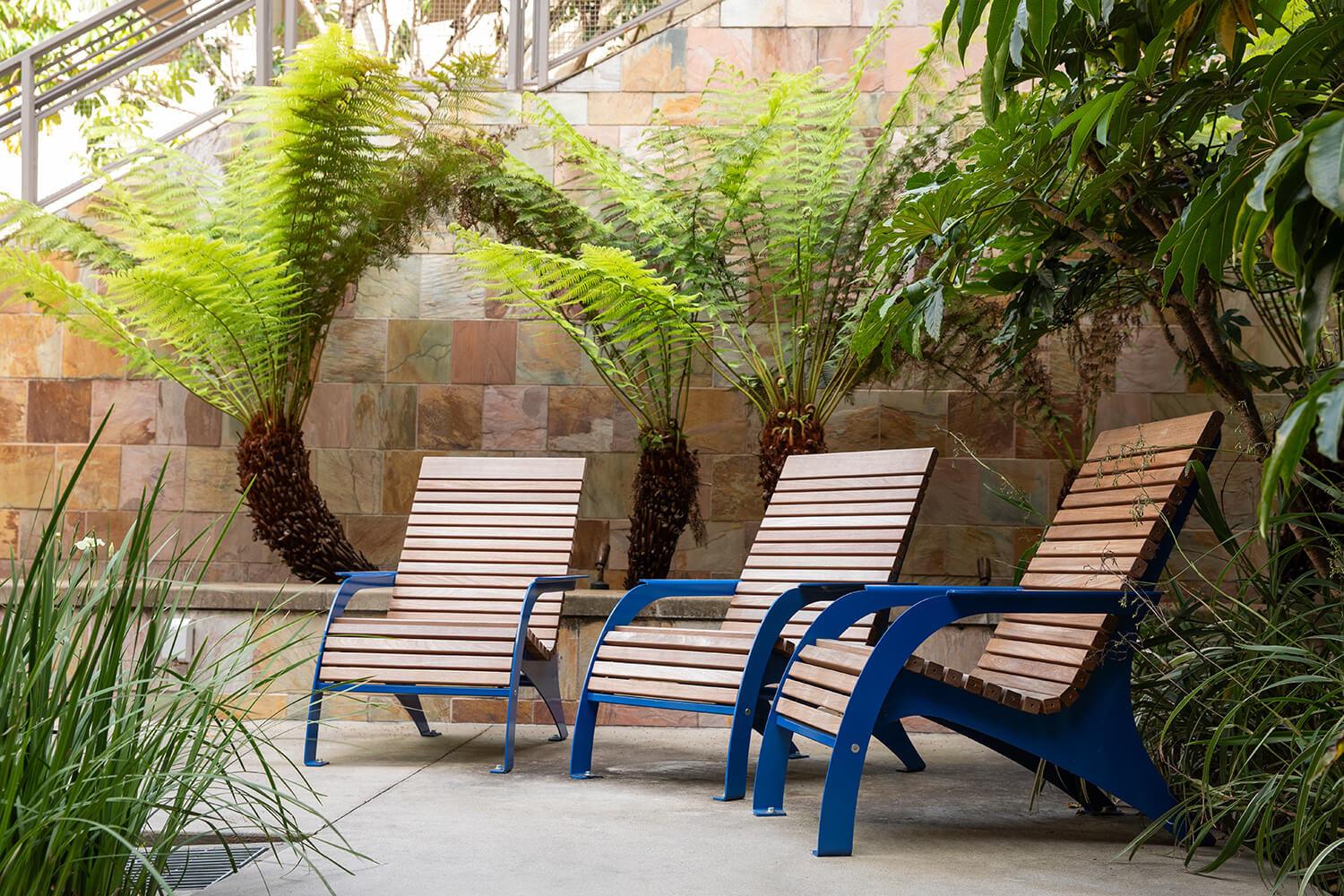Maglin 720 Chairs seated next to palm trees on CSUSM patio