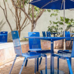 Maglin ALUM Cafe Chairs with Foro tables painted bright blue on CSUSM patio