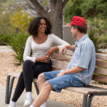 University students chatting on a Maglin Iconic bench while enjoying the outdoors at CSUSM