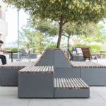Maglin Pixel Blocks configured to allow seating on a patio with a student studying in the background at CSUSM