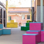 Brightyl painted Pixex block configurations line a walkway at Camp North End