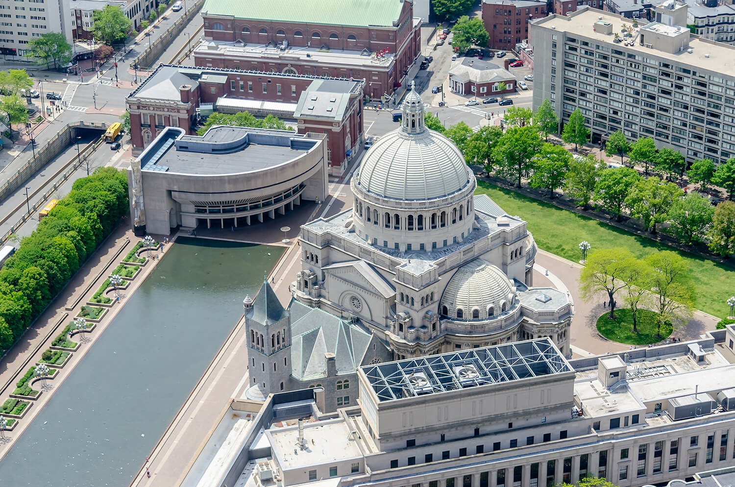 Christian Science Plaza overhead view of building with lush trees and water feature