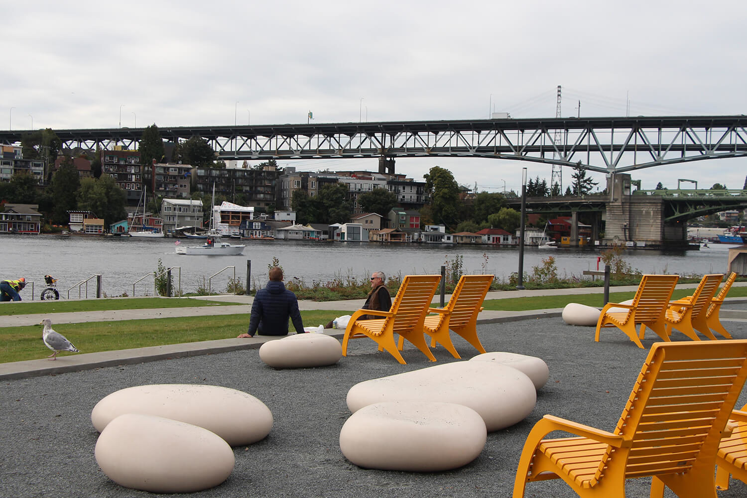 720 Maglin chairs overlooking waterfront with bridge in background and two men chatting
