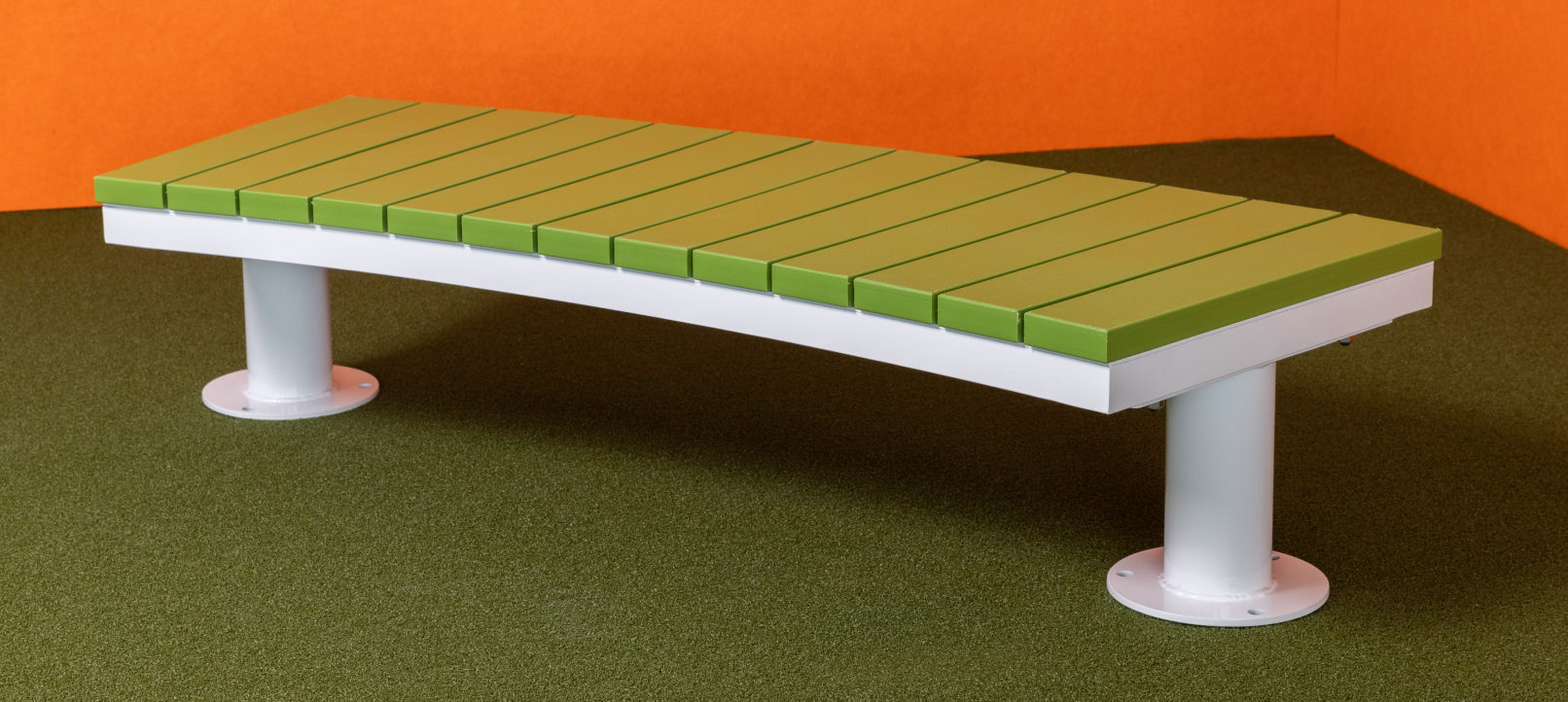 Bench-2-1 A modern bench with a green slatted seat and white metal legs, placed on green carpet with orange walls in the background.