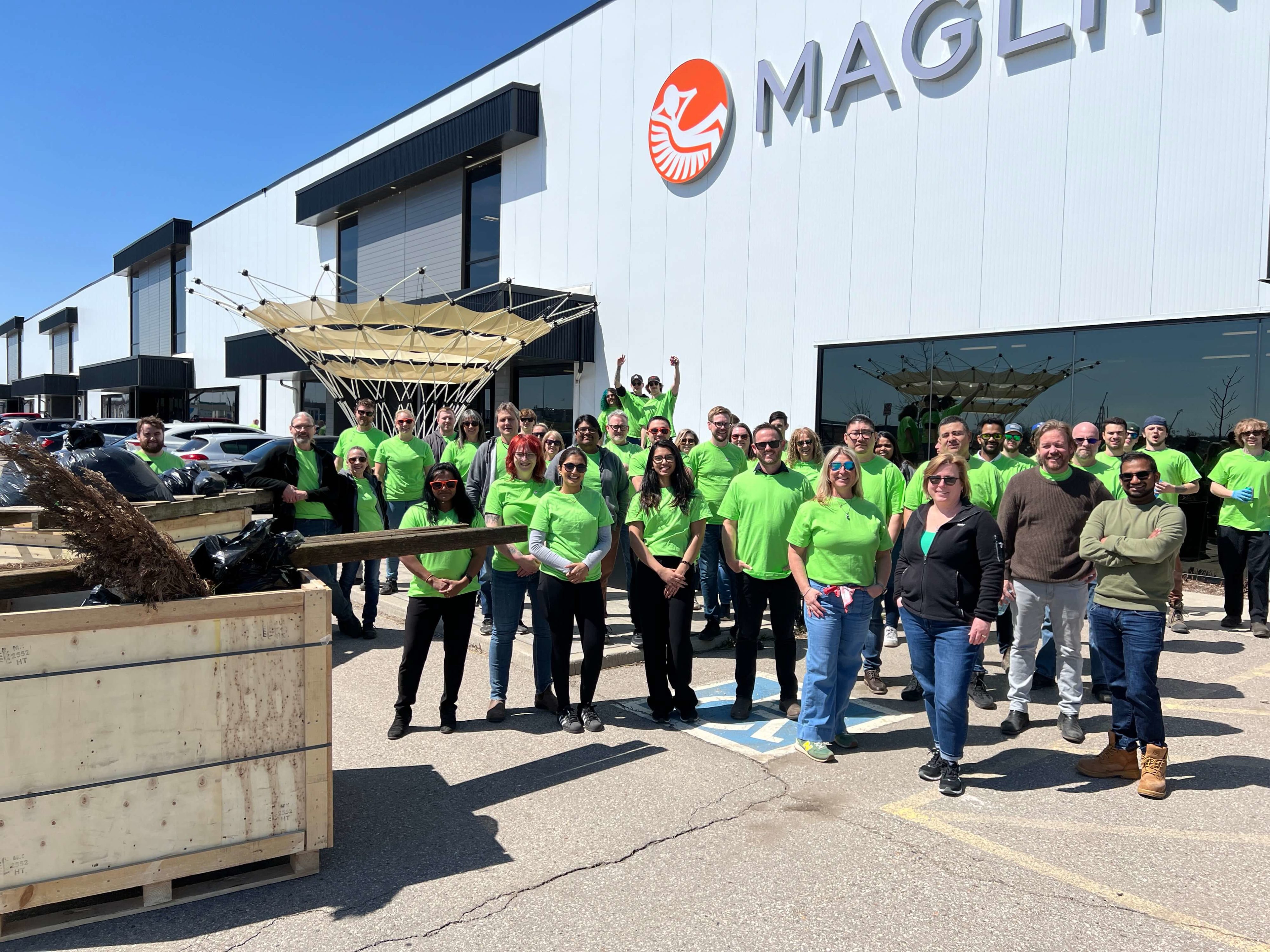 Maglin employees celebrate after completing the spring cleanup on Earth Day 2025