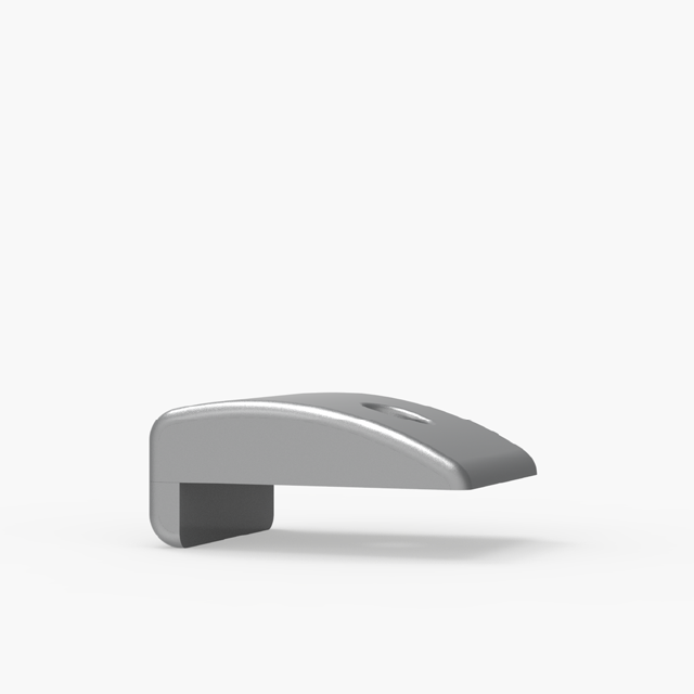 A gray, curved, rectangular object with a slot underneath and a small circular indentation on top, set against a plain white background.