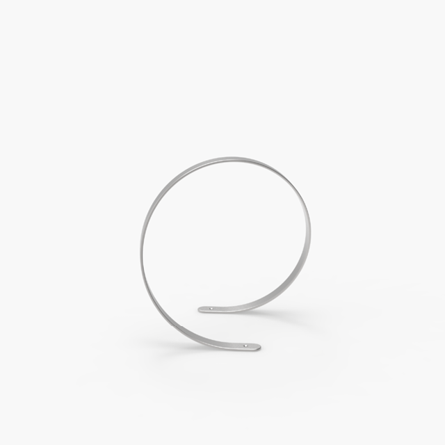 A minimalist, silver metallic stand shaped in a smooth, continuous spiral resting on a white surface.