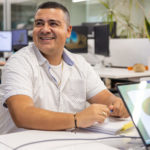 Luis and Lisa smile during a meeting at Maglin Site Furniture HQ.