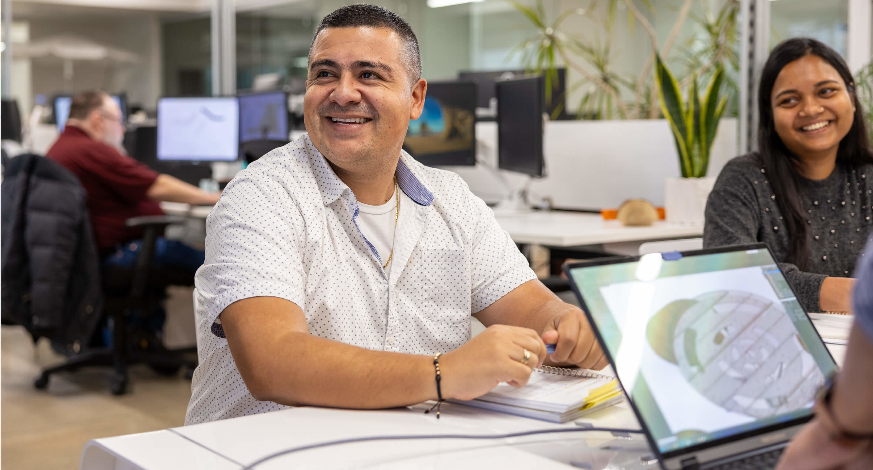 Luis and Lisa smile during a meeting at Maglin Site Furniture HQ.