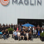 Maglin team posing outside Maglin head office on sunny day
