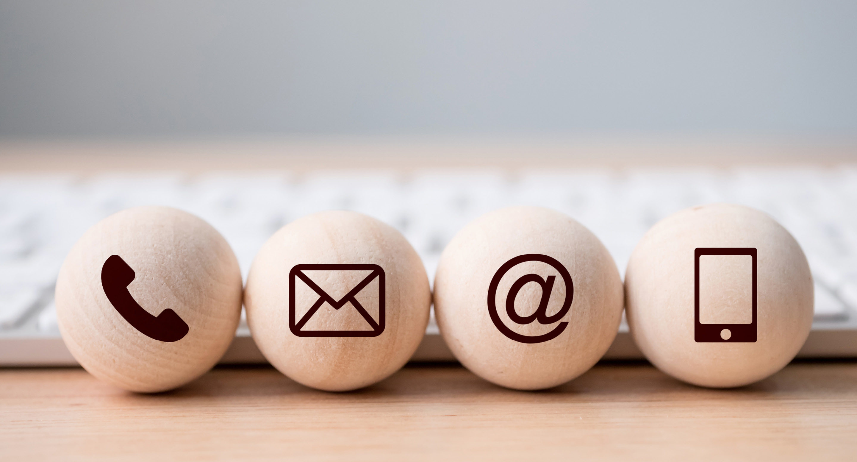 Contact icons - phone, email, @ and mobile on wooden balls