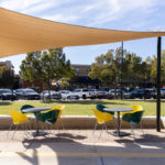 Battery chairs and Foro table painted yellow and green under shade structure