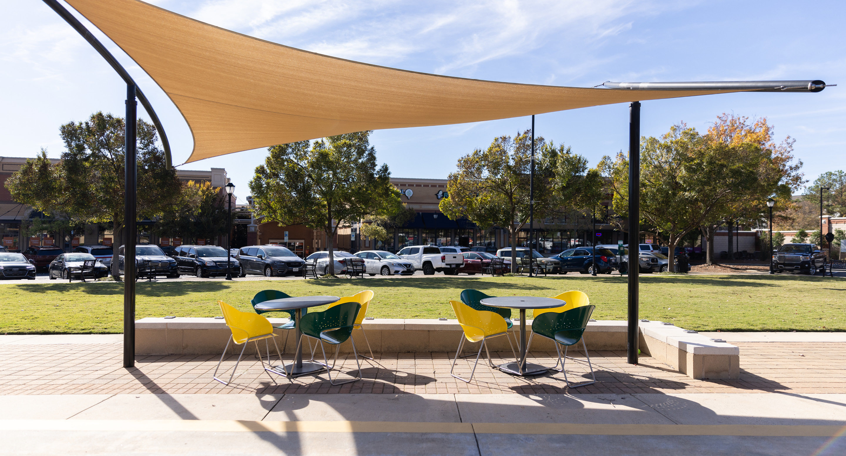Battery chairs and Foro table painted yellow and green under shade structure