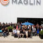 A drone image of Maglin employees waving in front of the Maglin headquarters.