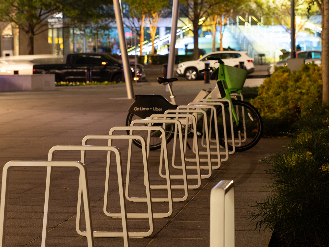 Row of Iconic bike racks on streetscape with cars in background