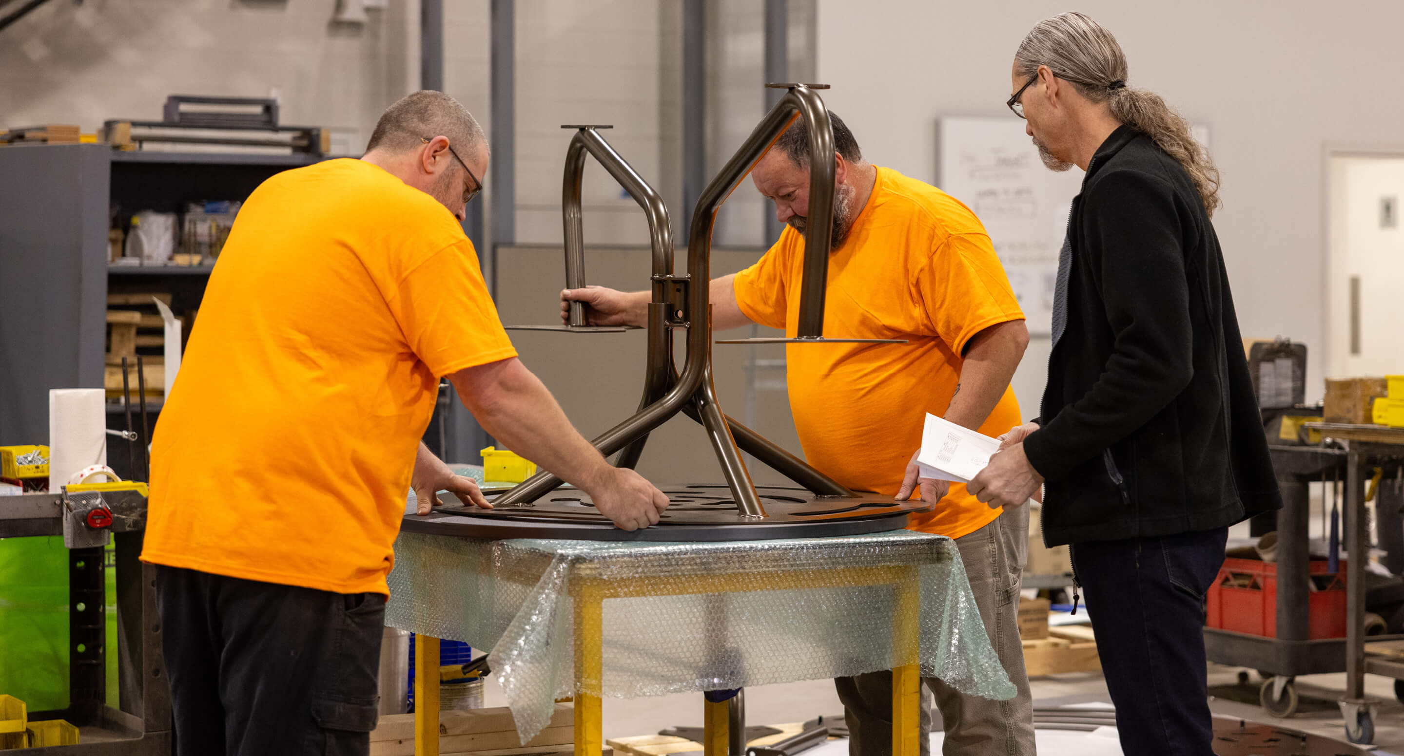 Maglin employees Steve, Rodney, and Mike assemble Fava Cluster Seating at the Maglin warehouse.