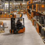 Maglin employees work in the production warehouse.
