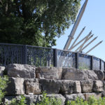 Custom FLEXX panels on rocks edge with trees and pipes