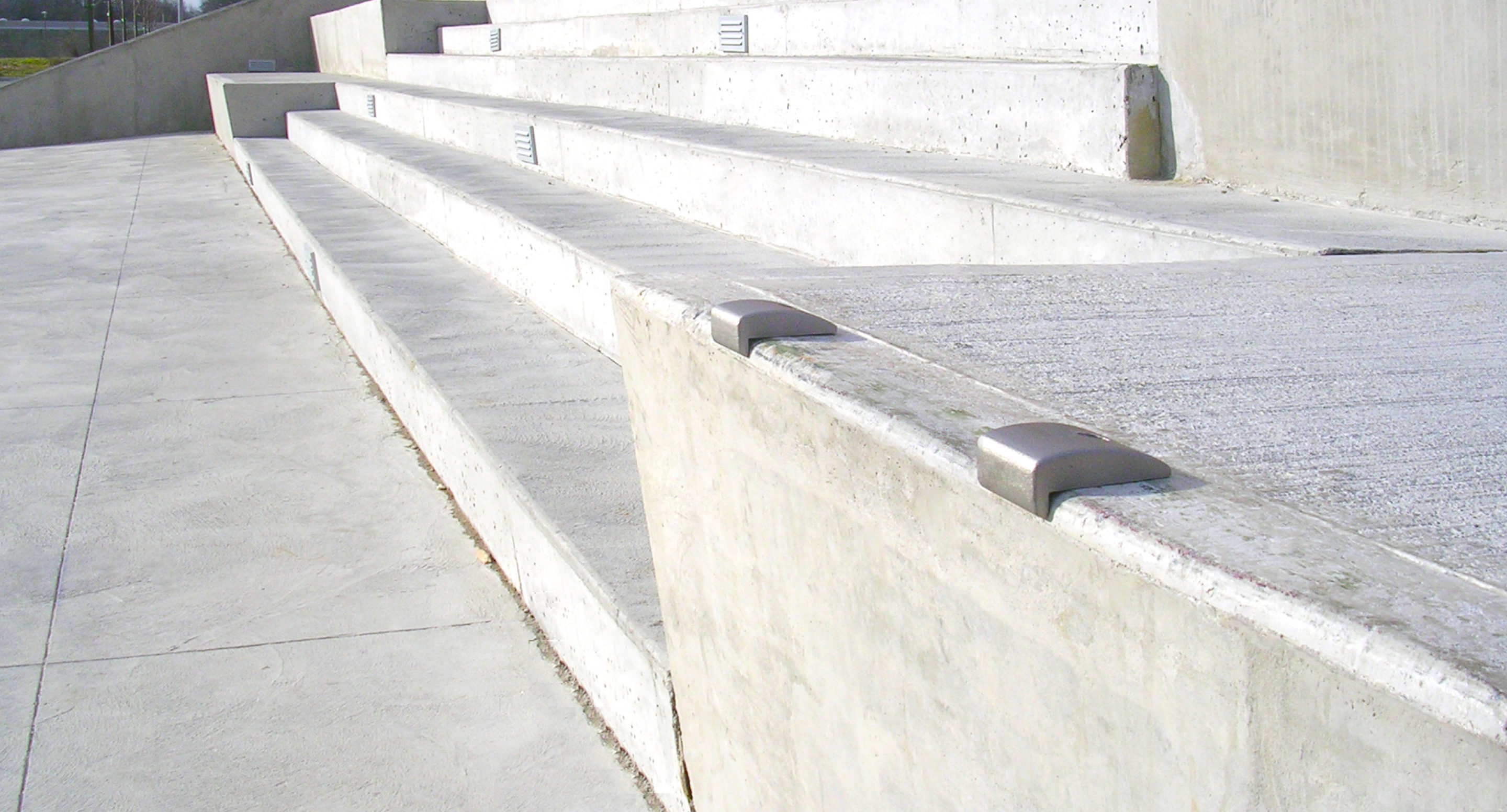 maglin_mac-0300-wall-mount-skate-deterrents-1 Concrete steps with metal skate deterrents installed along the edges, preventing skateboarding or grinding activities.