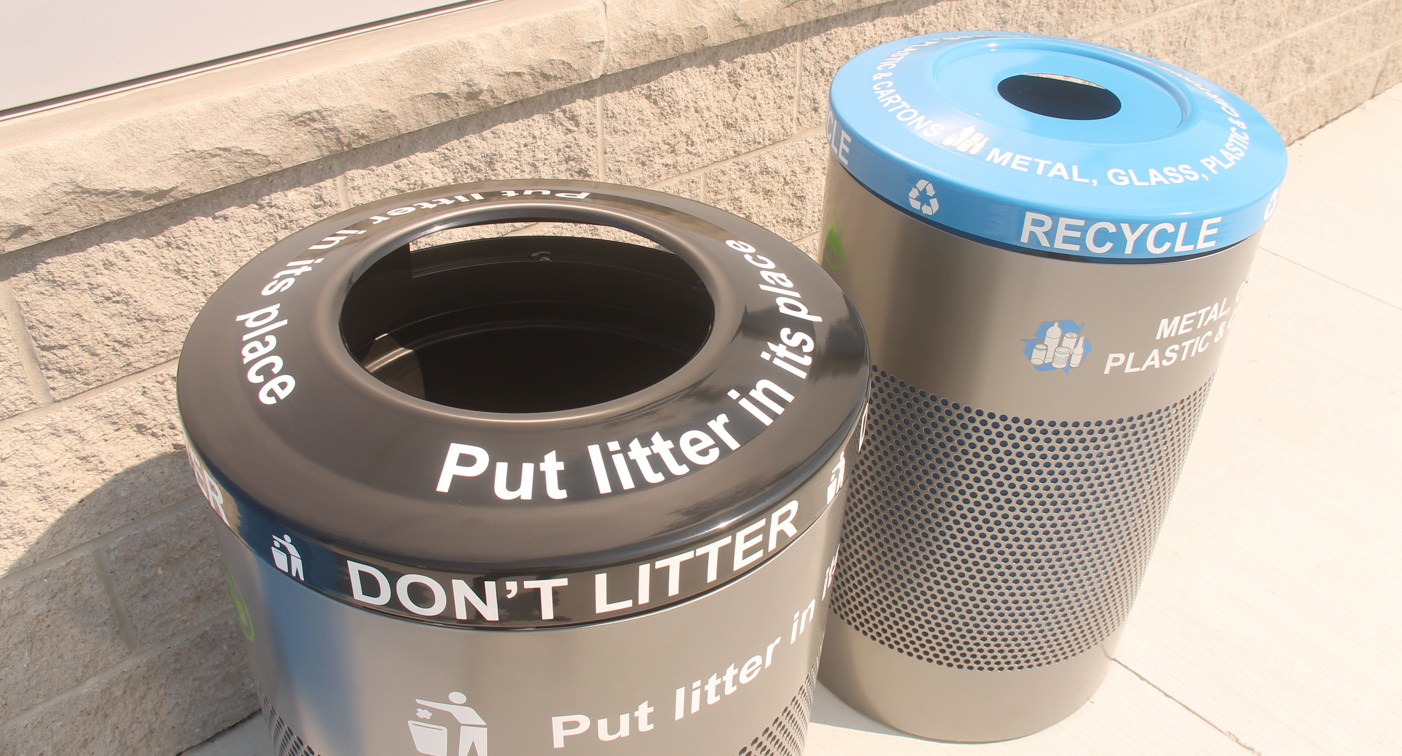 maglin_mtr-0600-trash-receptacles-3-0613 Two outdoor bins side by side: a black trash bin labeled