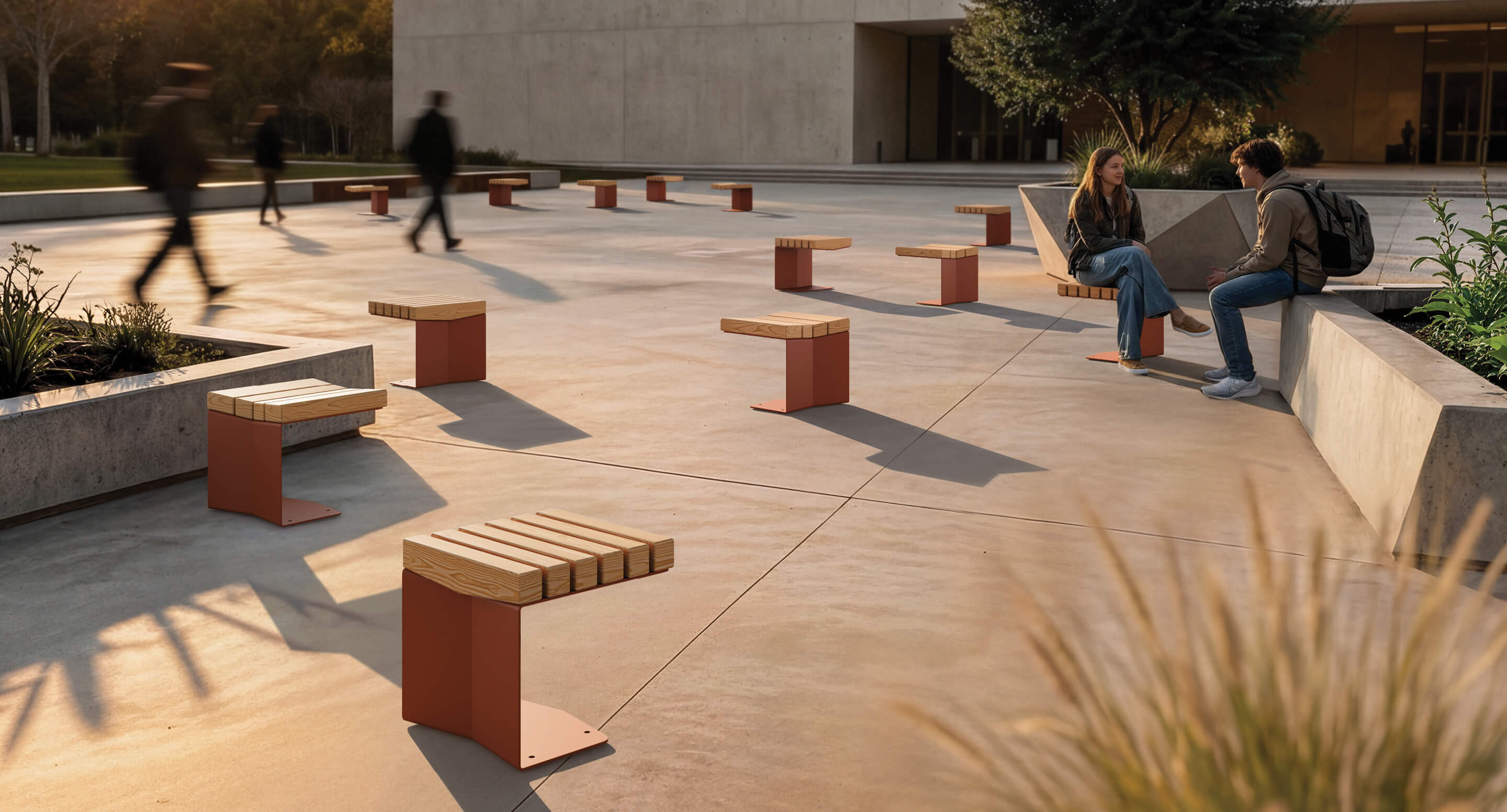 maglin_blox-stools_01 A modern outdoor plaza with spaced wooden benches; two people are seated and talking while others walk by in the background.