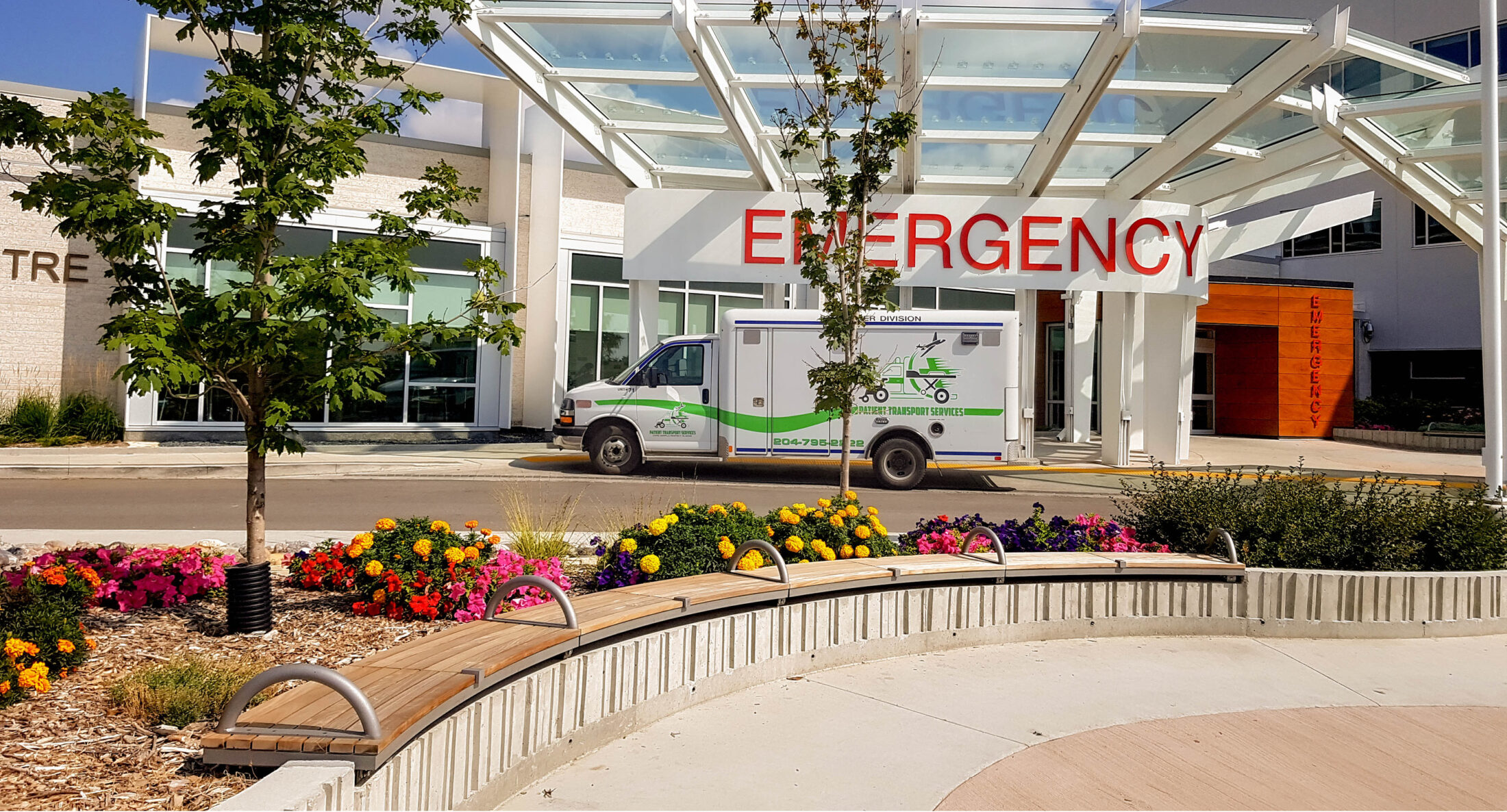 A patient transport van parked under the Emergency Department entrance at Grace Hospital.